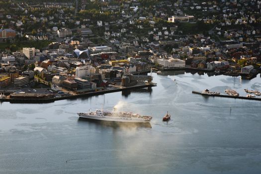 Bird's eye view. of a steam boat leaving city of Tromso, Norway.