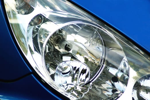 Headlight of a blue car.