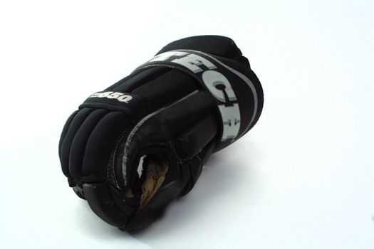 Used black hockey glove isolated over white background