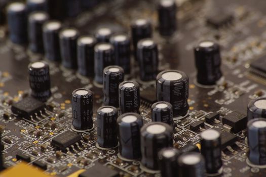 Detail of PC sound card with shallow depth of field to focus on some capacitors