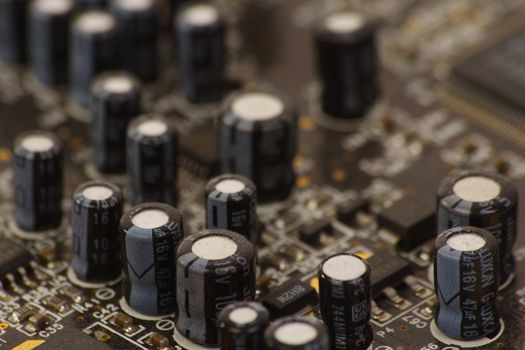 Detail of PC sound card with shallow depth of field to focus on some capacitors
