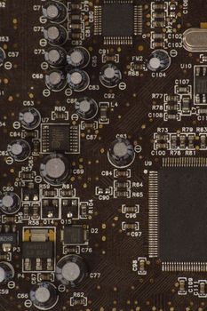 Detail of PC sound card with shallow depth of field to focus on some capacitors