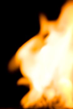 blurry fire flames raising in a dark background