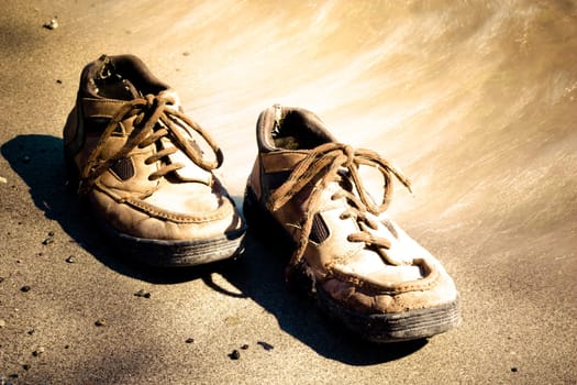 lonely pair of shoes on a lakeshore send