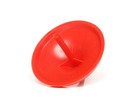 Red spinning top isolated over white background