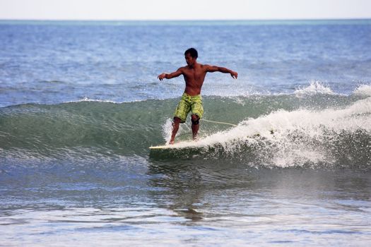 Young men - the surfer in ocean. Bali. Indonesia