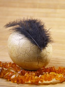 easter egg with feathers and amber Necklace on tatami style matting