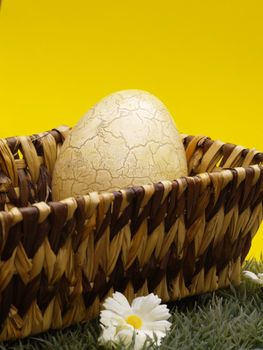 Basket with easter egg yellow background