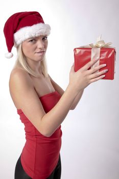 Beautiful Blond Girl With Santa Hat Holding A Christmas Present