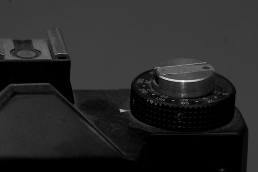 Old analog photo camera in black background