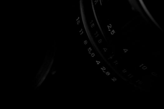 Old analog photo camera in black background