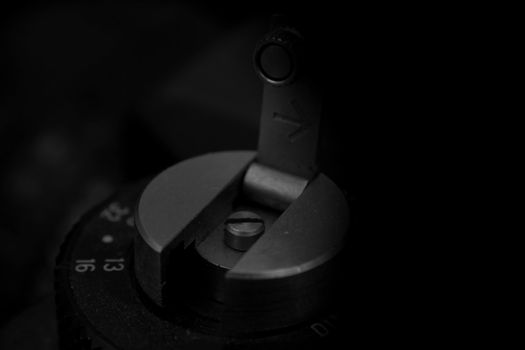 Old analog photo camera in black background