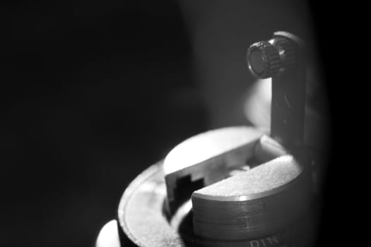 Old analog photo camera in black background