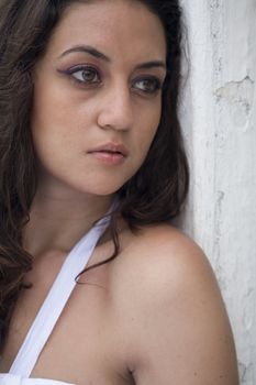 A young brazilian brunette wearing a white dress.