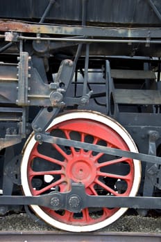 Old locomotive wheel close up. Steam train.