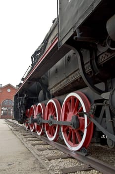 Old locomotive wheels close up. Steam train.