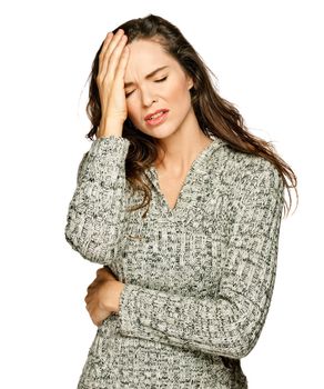 A young attractive woman suffering from illness or headache holding her head. Isolateed on white.