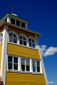 An old yellow building, a fine summer day, blue sky.