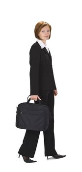 Businesswoman with computer bag walking.