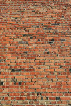 Brickwall over blue sky showing unique pattern.
