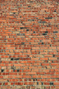 Brickwall over blue sky showing unique pattern.
