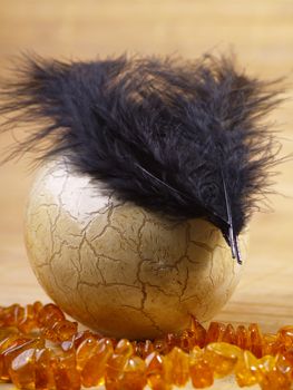 easter egg with feathers and amber Necklace on tatami style matting