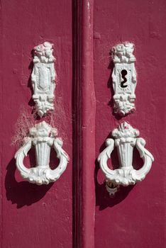 Old door knobs on wooden door.