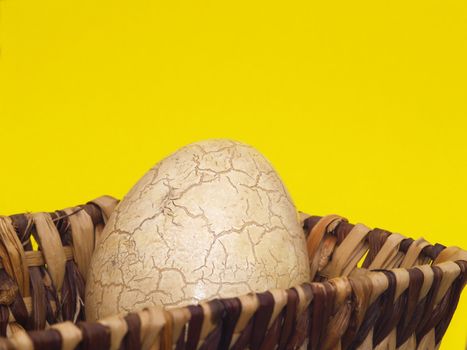 Basket with easter egg yellow background