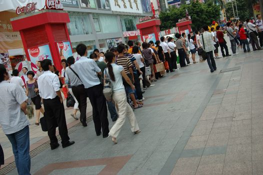 CHINA, SHENZHEN - AUGUST 20: overpopulated city in Guangdong province. Crowd of people waits in queue and pushes to the buses after work.