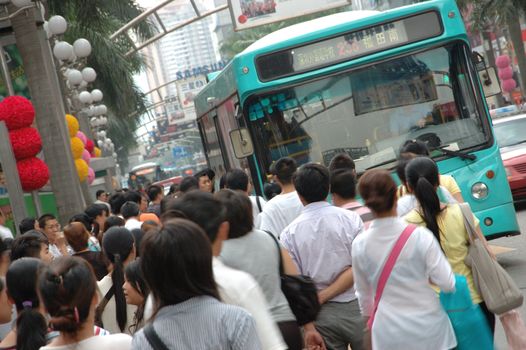 CHINA, SHENZHEN - AUGUST 20: overpopulated city in Guangdong province. Crowd of people waits in queue and pushes to the buses after work.