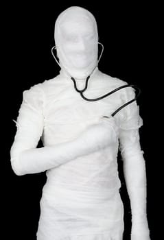 Man in costume mummy with stethoscope on black