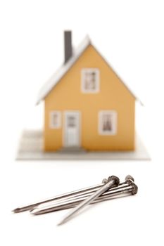 House and Nails Isolated on a White Background.