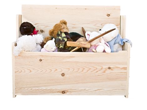 Various toys in a hand crafted toy box isolated on white background.