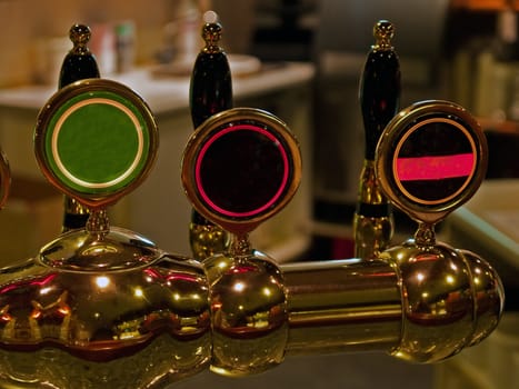 Beer taps spigot in a pub bar background