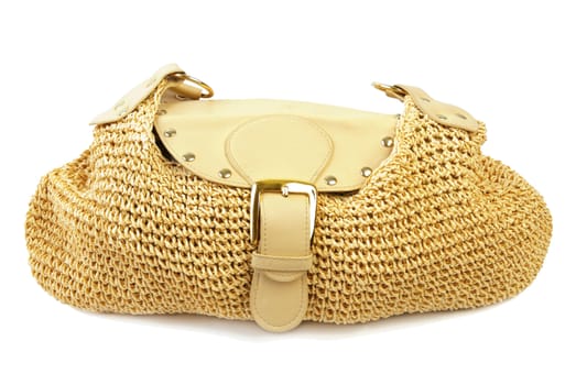 Golden female handbag with leather and textile elements. Isolated on white background