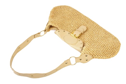 Golden female handbag with leather and textile elements. Isolated on white background