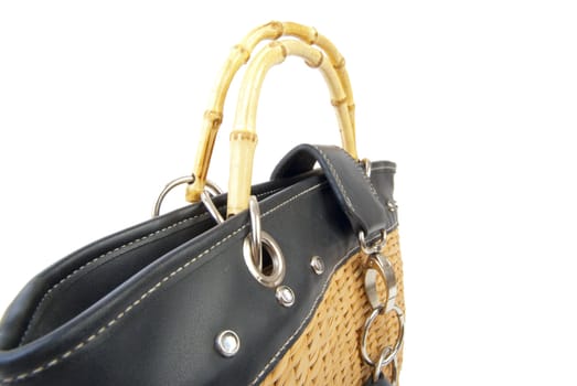 Wattled handbag with leather and steel elements. Isolated on white background