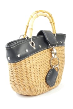 Wattled handbag with leather and steel elements. Isolated on white background