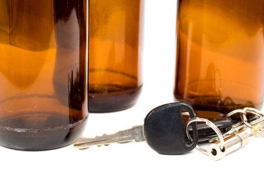Concept image of drinking and driving with a shot of some car keys beside some empty beer bottles