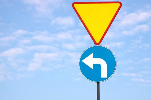 Triangle traffic sign with blue sky and clouds background