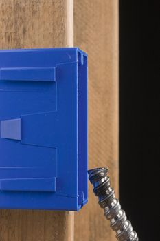 Blue switch box next to a metal cable.