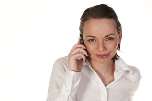 Beautiful girl speaking on the phone, seen against white background