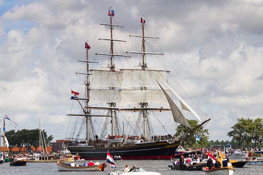 SAIL AMSTERDAM 2010 -IJMUIDEN, THE NETHERLANDS - AUGUST 2010: Sail 2010 starts with the spectaculair Sail-in Parade.  50 Tall ships and more than 500 of  naval ships, replicas and yachts sail in convoy through the North Sea Canal from IJmuiden to Amsterdam. Thousands of private boats accompany the fleet and more than 300.000 visitors watch the parade from the banks. August 19, 2010, IJmuiden, the Netherlands