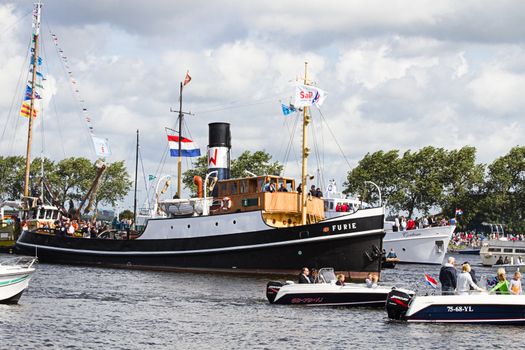 SAIL AMSTERDAM 2010 -IJMUIDEN, THE NETHERLANDS - AUGUST 2010: Sail 2010 starts with the spectaculair Sail-in Parade.  50 Tall ships and more than 500 of  naval ships, replicas and yachts sail in convoy through the North Sea Canal from IJmuiden to Amsterdam. Thousands of private boats accompany the fleet and more than 300.000 visitors watch the parade from the banks. August 19, 2010, IJmuiden, the Netherlands