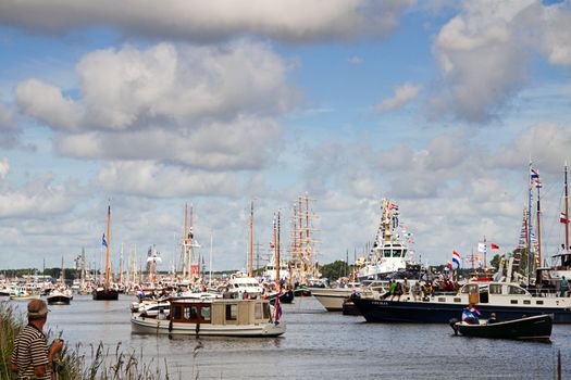 SAIL AMSTERDAM 2010 -IJMUIDEN, THE NETHERLANDS - AUGUST 2010: Sail 2010 starts with the spectaculair Sail-in Parade.  50 Tall ships and more than 500 of  naval ships, replicas and yachts sail in convoy through the North Sea Canal from IJmuiden to Amsterdam. Thousands of private boats accompany the fleet and more than 300.000 visitors watch the parade from the banks. August 19, 2010, IJmuiden, the Netherlands