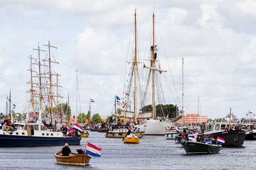 SAIL AMSTERDAM 2010 -IJMUIDEN, THE NETHERLANDS - AUGUST 2010: Sail 2010 starts with the spectaculair Sail-in Parade.  50 Tall ships and more than 500 of  naval ships, replicas and yachts sail in convoy through the North Sea Canal from IJmuiden to Amsterdam. Thousands of private boats accompany the fleet and more than 300.000 visitors watch the parade from the banks. August 19, 2010, IJmuiden, the Netherlands