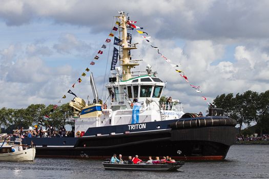 SAIL AMSTERDAM 2010 -IJMUIDEN, THE NETHERLANDS - AUGUST 2010: Sail 2010 starts with the spectaculair Sail-in Parade.  50 Tall ships and more than 500 of  naval ships, replicas and yachts sail in convoy through the North Sea Canal from IJmuiden to Amsterdam. Thousands of private boats accompany the fleet and more than 300.000 visitors watch the parade from the banks. August 19, 2010, IJmuiden, the Netherlands