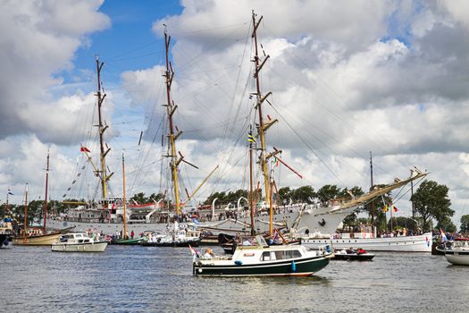 SAIL AMSTERDAM 2010 -IJMUIDEN, THE NETHERLANDS - AUGUST 2010: Sail 2010 starts with the spectaculair Sail-in Parade.  50 Tall ships and more than 500 of  naval ships, replicas and yachts sail in convoy through the North Sea Canal from IJmuiden to Amsterdam. Thousands of private boats accompany the fleet and more than 300.000 visitors watch the parade from the banks. August 19, 2010, IJmuiden, the Netherlands