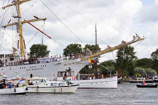 SAIL AMSTERDAM 2010 -IJMUIDEN, THE NETHERLANDS - AUGUST 2010: Sail 2010 starts with the spectaculair Sail-in Parade.  50 Tall ships and more than 500 of  naval ships, replicas and yachts sail in convoy through the North Sea Canal from IJmuiden to Amsterdam. Thousands of private boats accompany the fleet and more than 300.000 visitors watch the parade from the banks. August 19, 2010, IJmuiden, the Netherlands