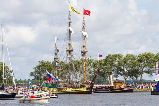 SAIL AMSTERDAM 2010 -IJMUIDEN, THE NETHERLANDS - AUGUST 2010: Sail 2010 starts with the spectaculair Sail-in Parade.  50 Tall ships and more than 500 of  naval ships, replicas and yachts sail in convoy through the North Sea Canal from IJmuiden to Amsterdam. Thousands of private boats accompany the fleet and more than 300.000 visitors watch the parade from the banks. August 19, 2010, IJmuiden, the Netherlands